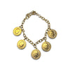 A gold-tone chain bracelet featuring five coin-shaped charms with profile portraits, photographed on a clean white background.
